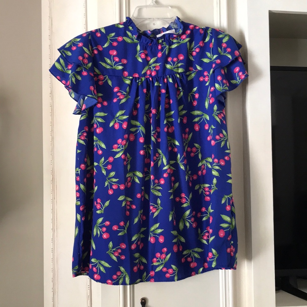 Adorable ruffle sleeve top. Never worn. Beautiful vivid colors.